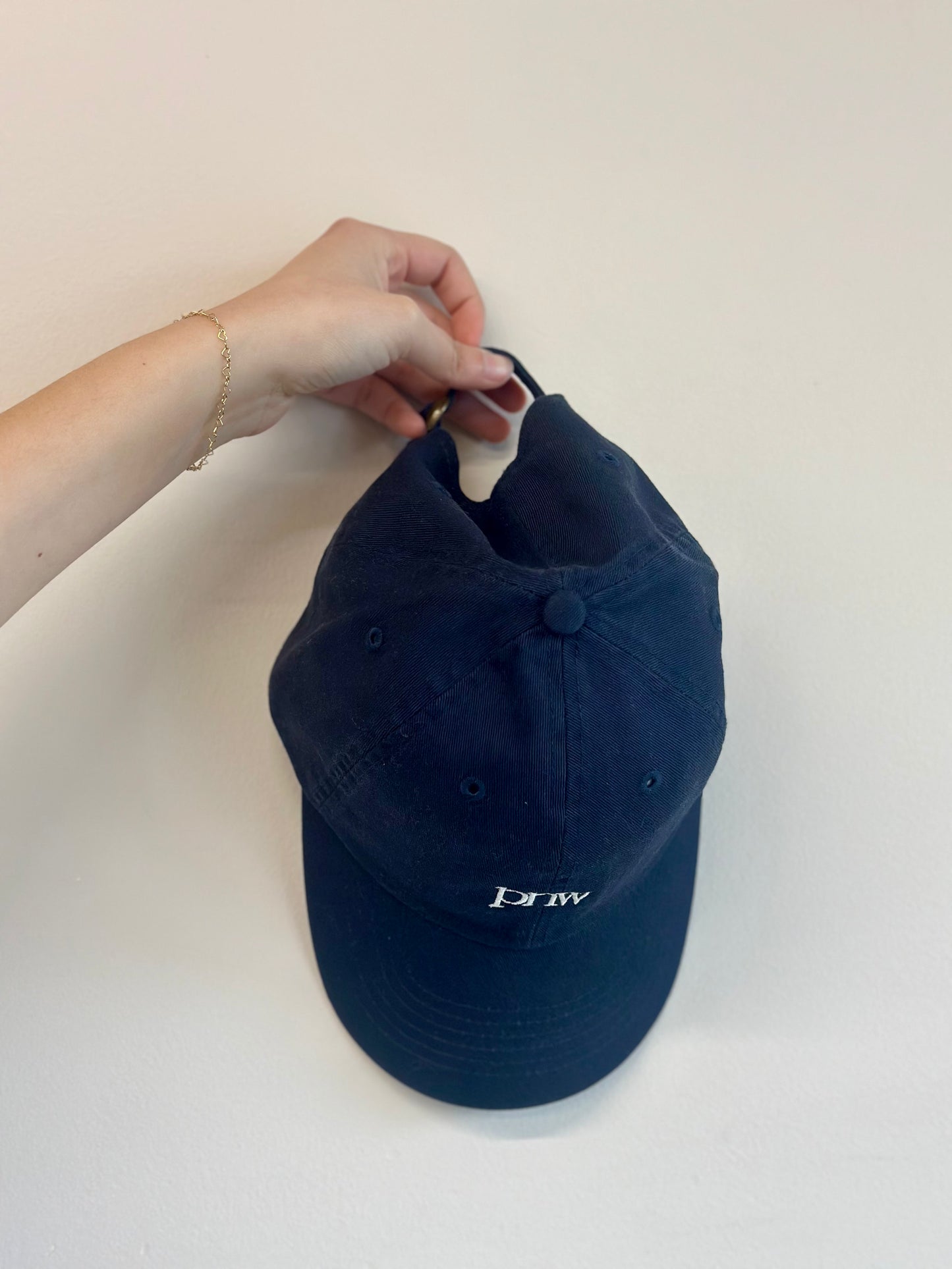Angled view showing embroidery and curved brim on navy PNW Dad Hat