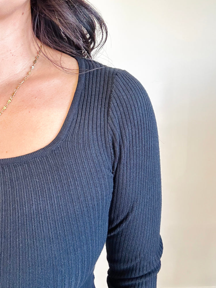 Close-up of black-colored fabric and square neckline of Allison top