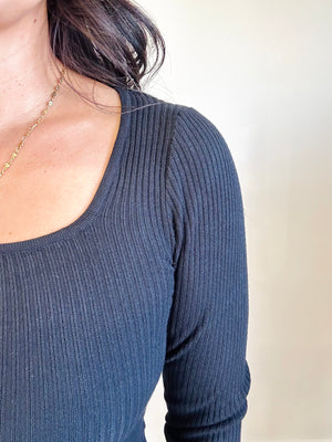 Close-up of black-colored fabric and square neckline of Allison top
