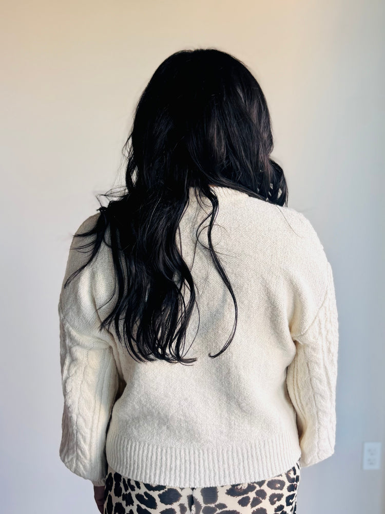 Back view of Anabelle sweater in cozy cable knit with lattice pattern