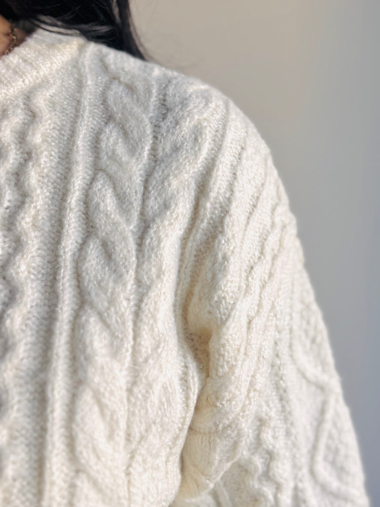 Close-up of braided cable knit and ribbed cuff texture on Anabelle sweater