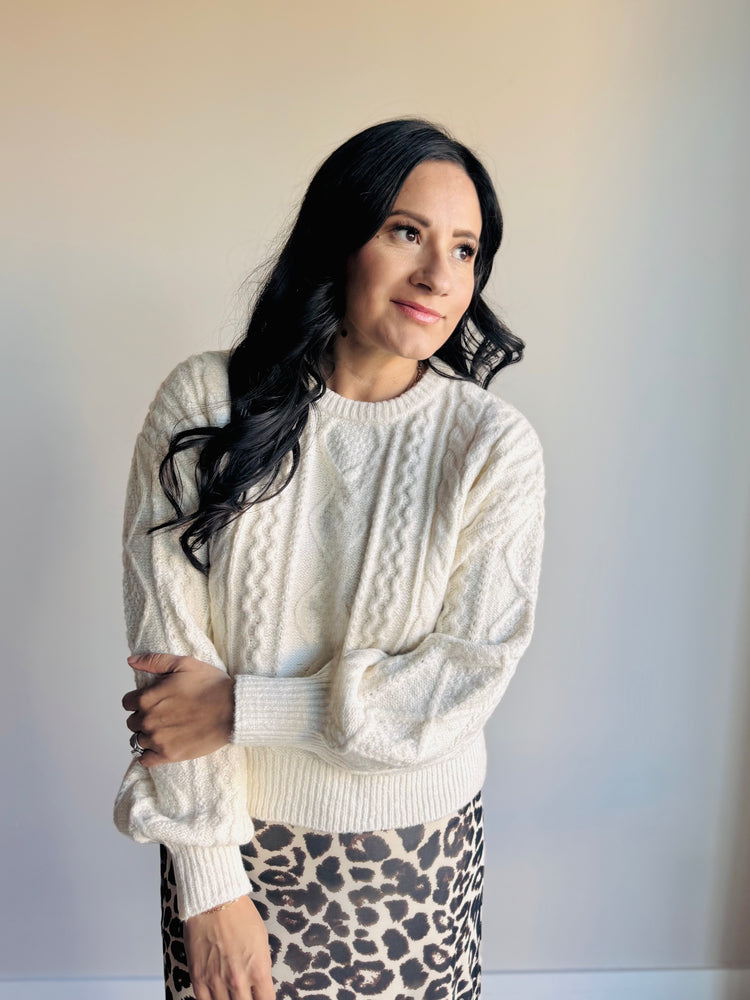 Front view of Anabelle cable knit sweater with braided rope texture and ribbed hem