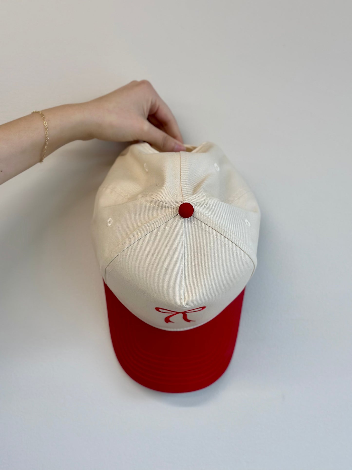 Angled view showing bow embroidery and two‑tone color contrast