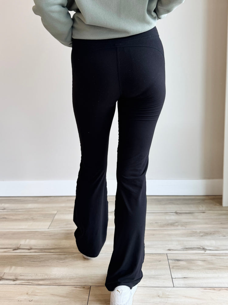 Back view of Butter Soft Flared Leggings in Black, emphasizing seamless design and comfortable waistband