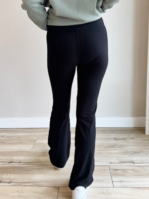 Back view of Butter Soft Flared Leggings in Black, emphasizing seamless design and comfortable waistband