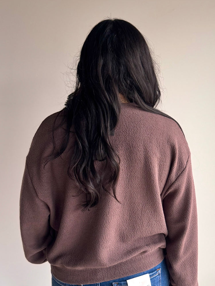 Back view of Chrissy knit top with relaxed silhouette and long sleeves