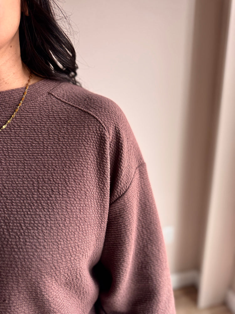 Close-up of mocha knit fabric and ribbed crewneck on Chrissy top