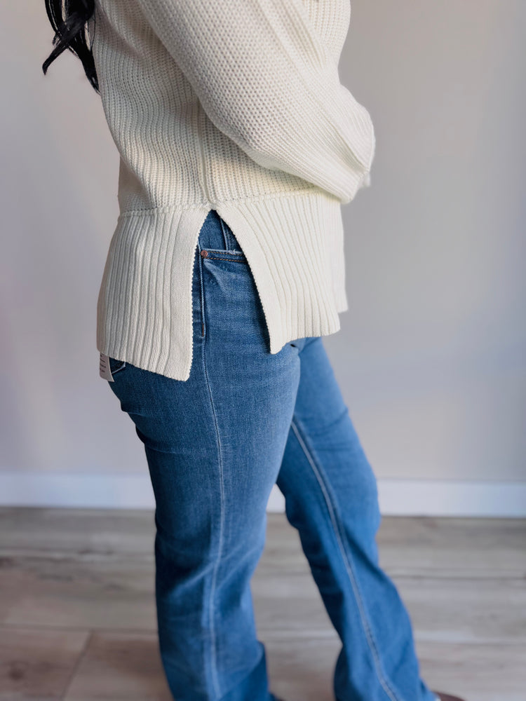 Side profile of Elle sweater showing deep side slits and soft cotton blend