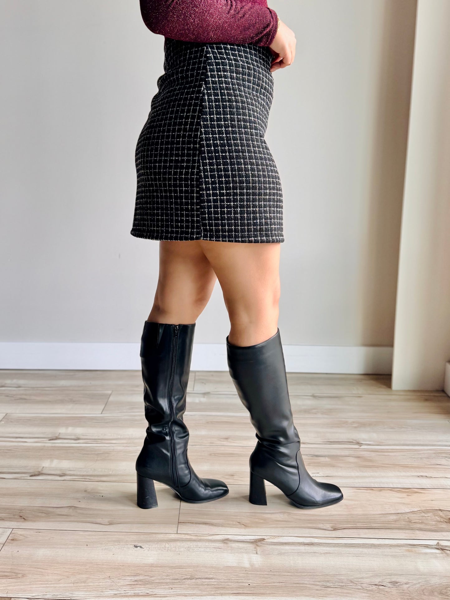 Side profile of Ellie tweed mini skirt showing tailored silhouette and chic tweed detail