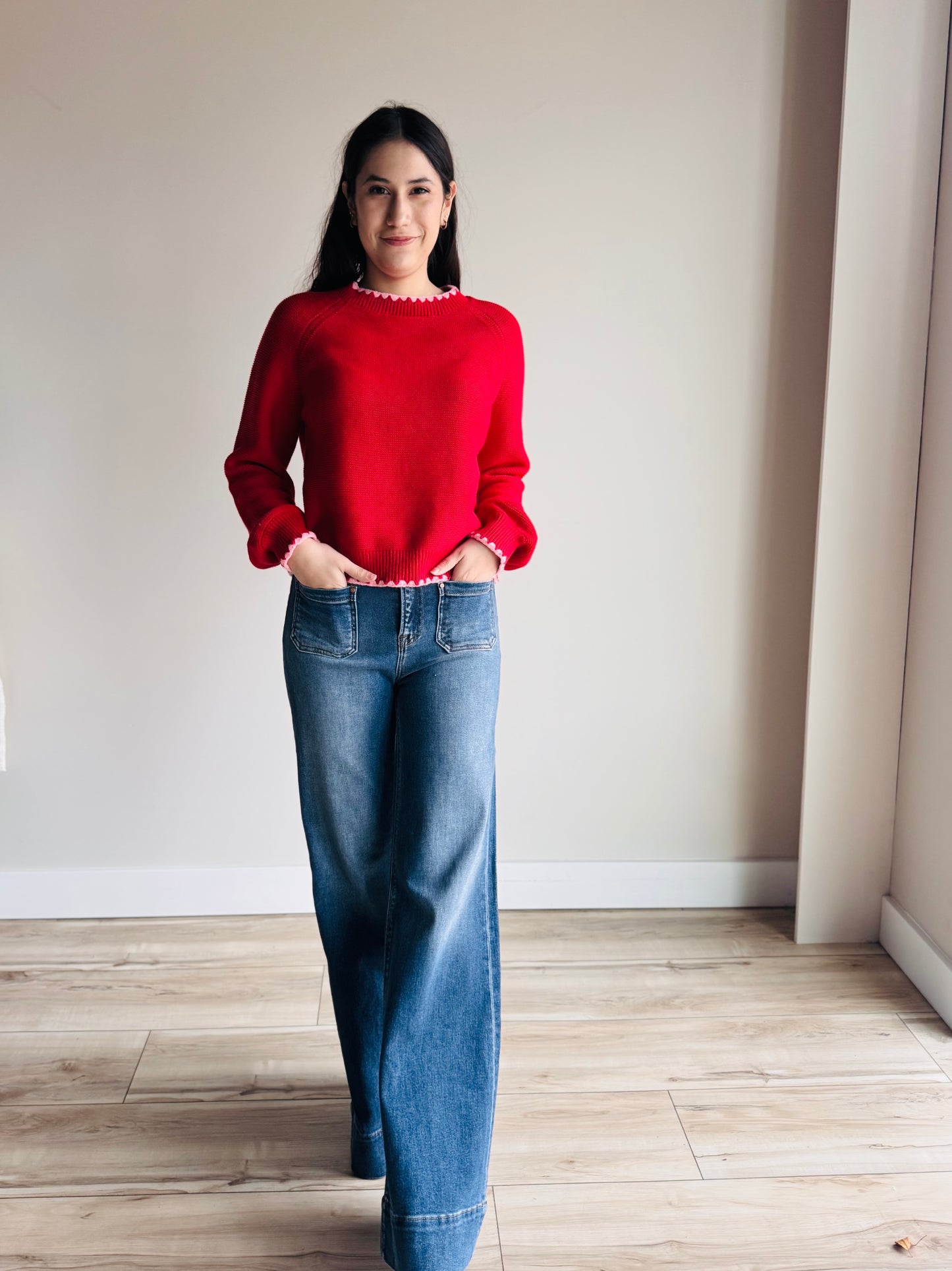 Front view of Emmalyn contrast hem knit sweater with layered detail and relaxed fit