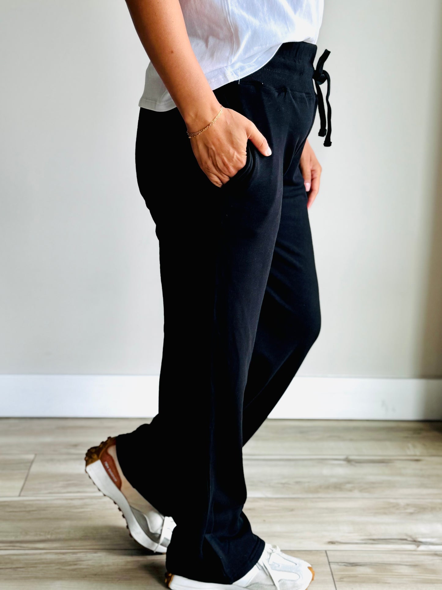 Side view of black Tencel relaxed pants smooth drape