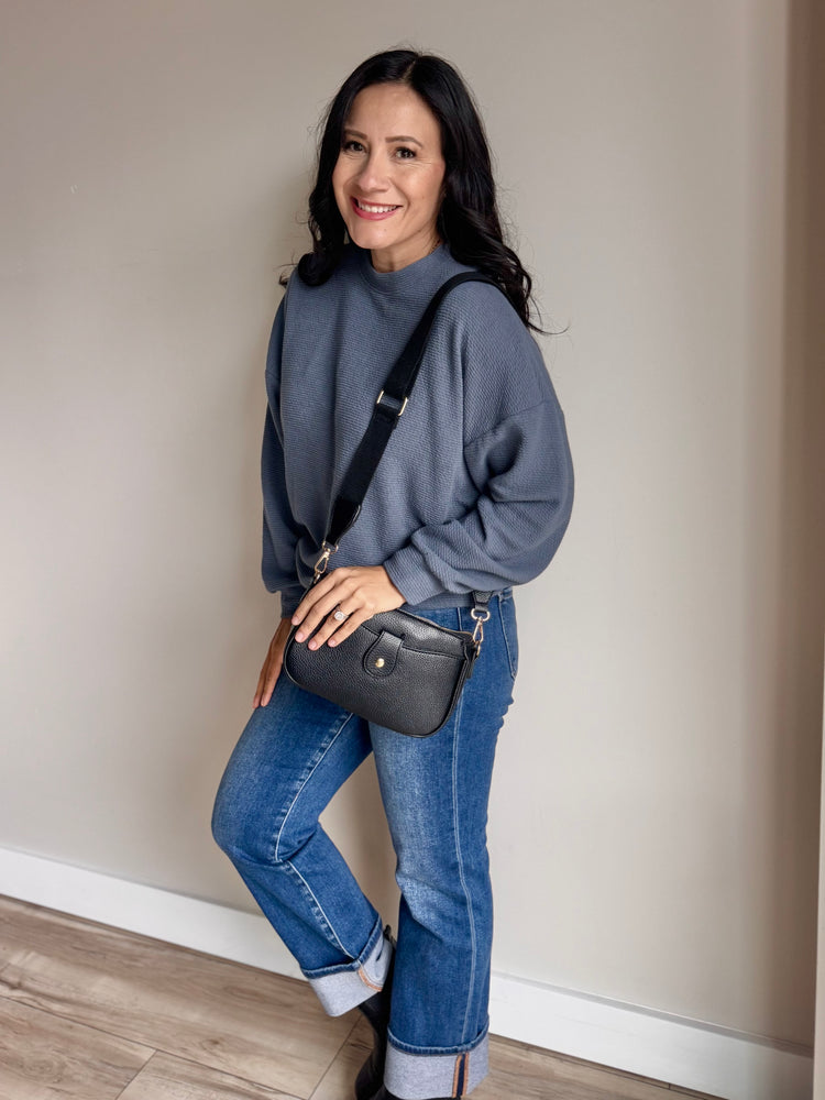 Side angle of Laurel top showing curved hem, side slit, and lightweight knit texture