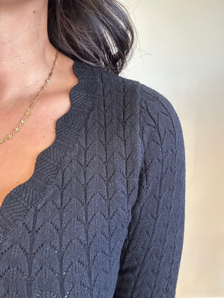 Close-up of soft pointelle knit texture and scalloped V-neckline of Lottie top