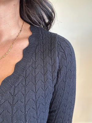 Close-up of soft pointelle knit texture and scalloped V-neckline of Lottie top