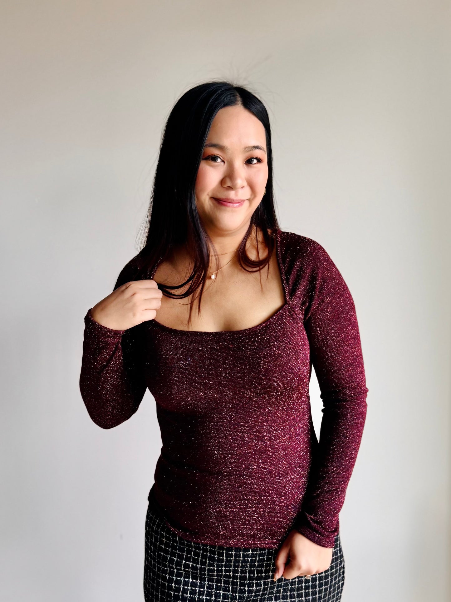 Side view of Maggie shimmer top showing silhouette and deep neckline