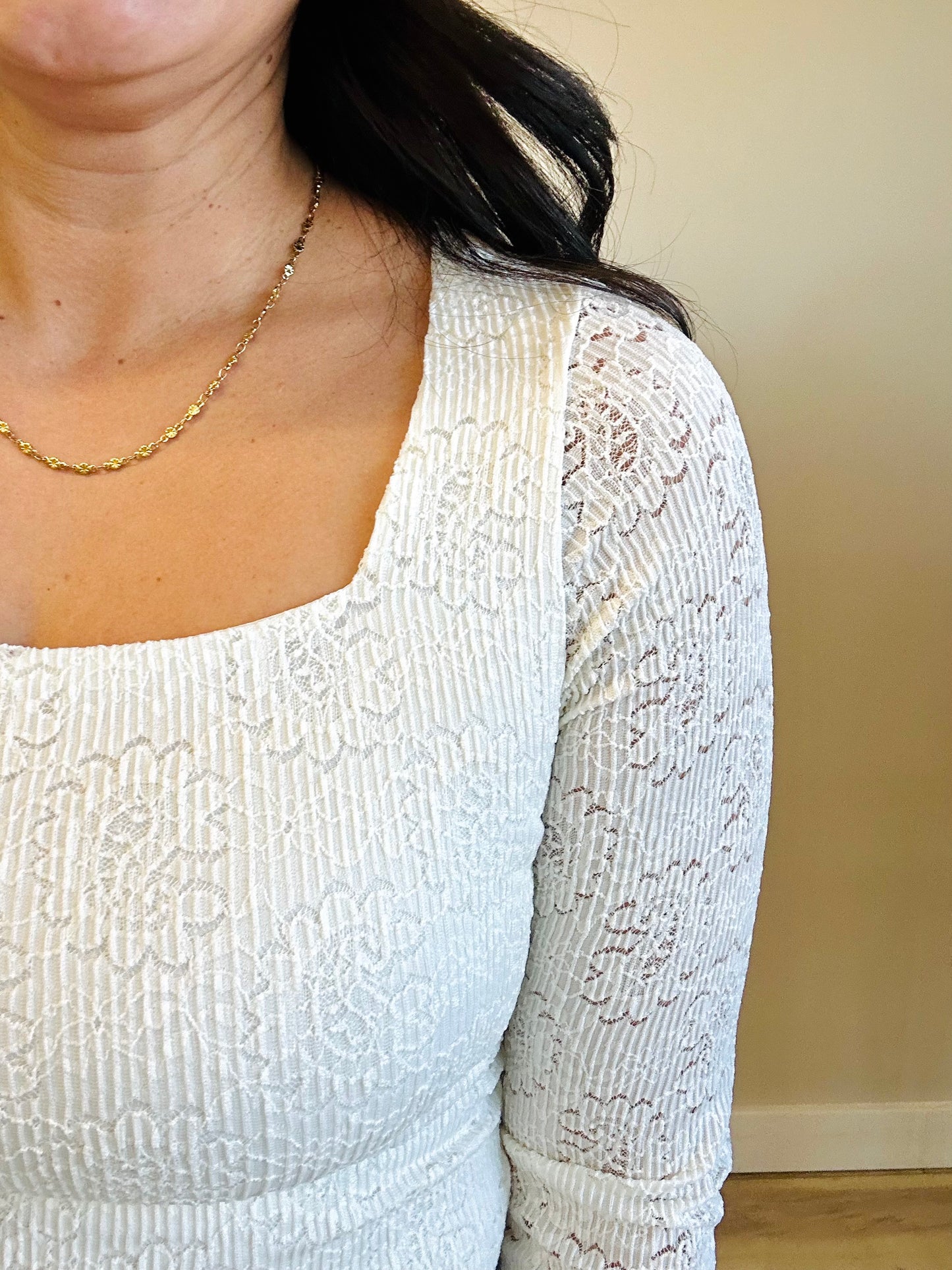 Close-up of intricate lace embroidery on Mara top in ivory