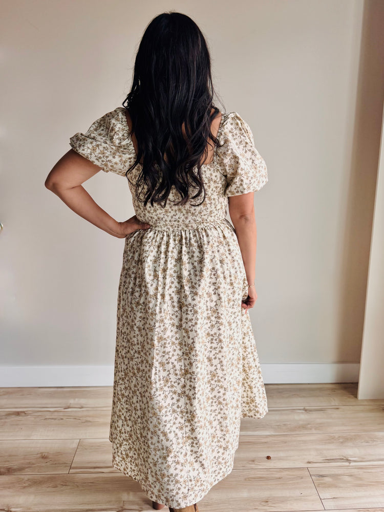 Side profile of floral midi dress showing smocked back and flattering silhouette