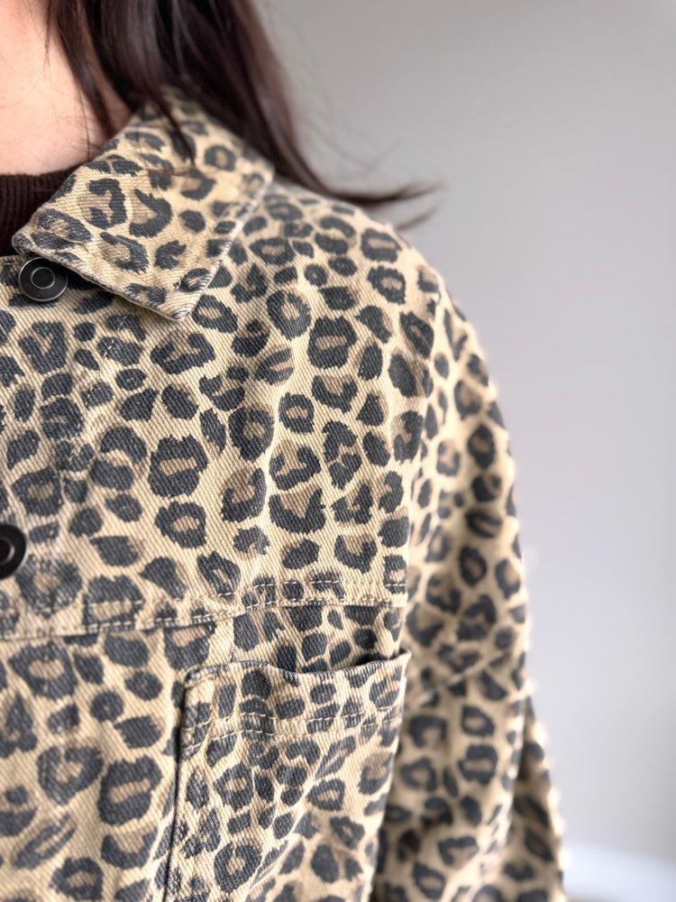 Close-up of animal print texture and button detail on Marlow denim jacket