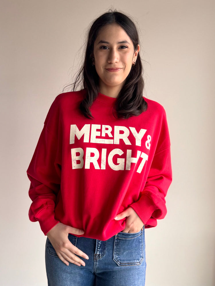 Front view of red and white Merry & Bright crewneck sweatshirt with festive graphic
