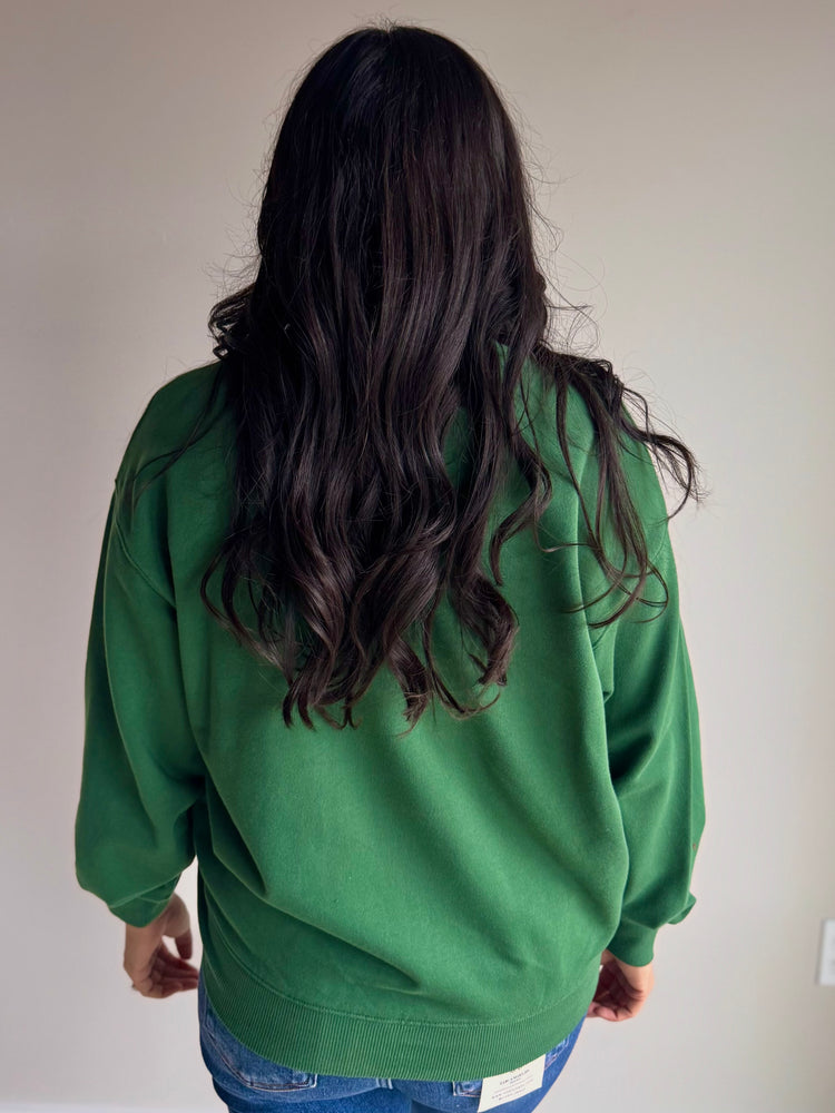 Back view of green and white crewneck with cozy silhouette and ribbed hem