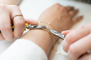 Customer receiving welded permanent bracelet at 27 West in Puyallup