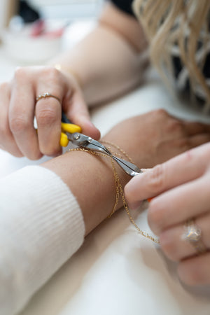 Close-up of sterling silver permanent jewelry chain and connectors at 27 West Puyallup