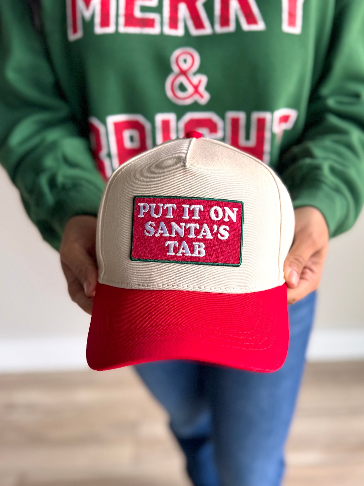 Front view of red Santa’s Tab patch hat with festive embroidery and snapback fit