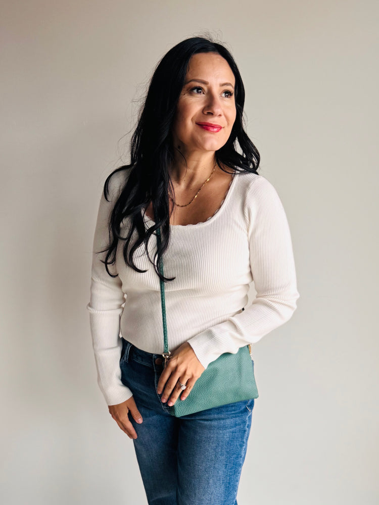 Side angle of Sedona purse in forest green with wristlet strap and gold hardware