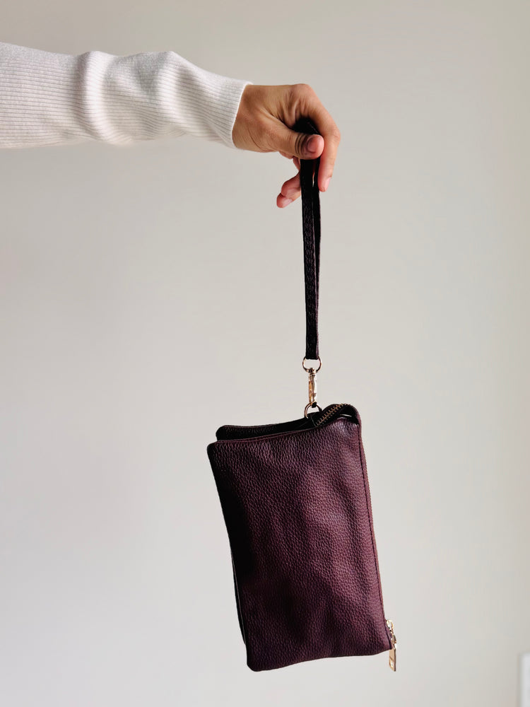 Side angle of Sedona purse in sangria red with wristlet strap and gold hardware