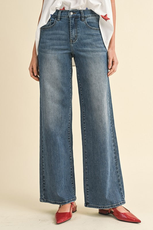 Model wearing Shay High Rise Wide Leg Denim in a casual setting, demonstrating versatility.